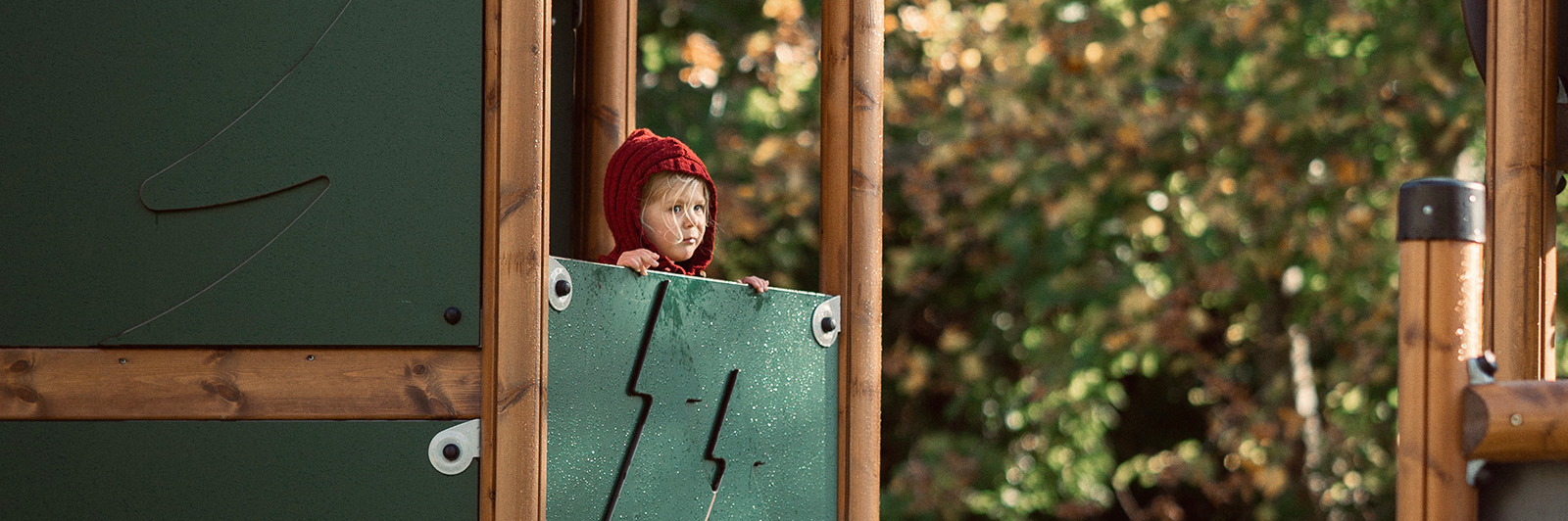 Girl looking out from a forets themed UniPlay unit.